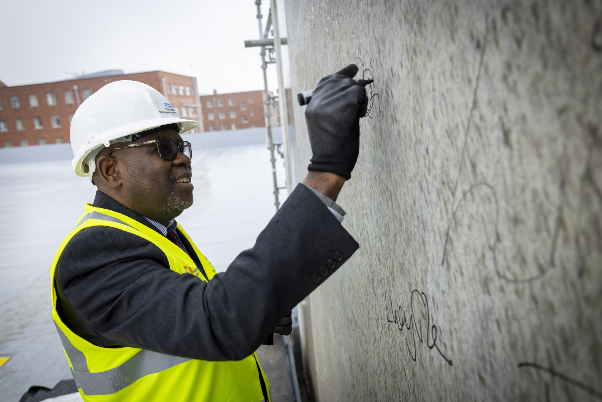 Olorunda Rotimi, clinical director for pathology, signs the stairwell of the building