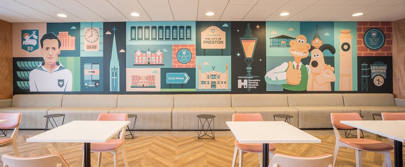 The mural also includes depictions of local landmarks and famous faces